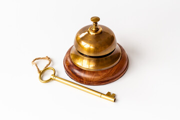 Fototapeta na wymiar Vintage golden hotel service bell with key
