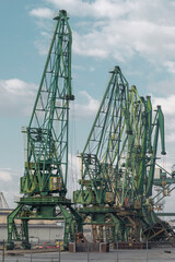 Fototapeta na wymiar Seaport cranes. Green dock cranes.