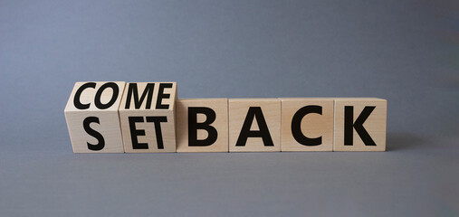 Comeback and setback symbol. Turned cubes with words setback and comeback. Beautiful grey...