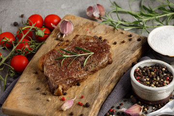 Grilled sliced beef steak well done on wooden cutting board. Top view.