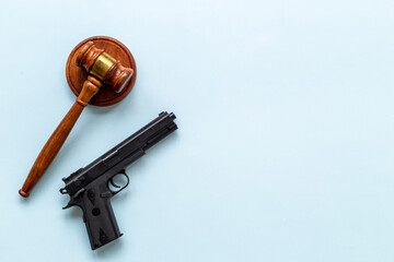 Hand gun weapon and judges gavel. Ban on carrying weapons gun law concept
