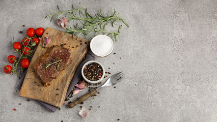 Grilled sliced beef steak on wooden cutting board. Panoramic top view. Free space for text.
