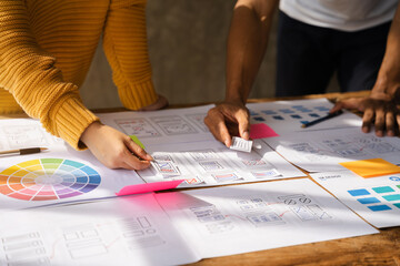 UX developer and ui designer brainstorming about mobile app interface wireframe design with...