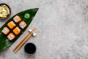 Salmon sushi rolls set on Bamboo leave, top view. Eco serving
