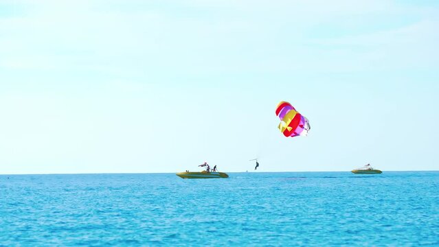 magnificent view of colorful parasail wing pulled by a boat in the bright blue sea, Alanya, Turkey. High quality 4k footage