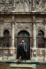 Fototapeta na wymiar Luxury couple posing near a black door. 