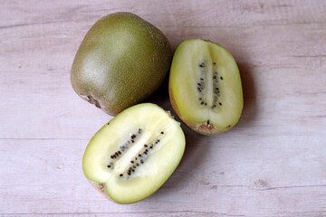 Food and drink, detail, background: closeup of halved and whole kiwi fruit