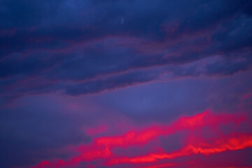 Fiery summer sunset landscape. Orange sun and dark blue sky
