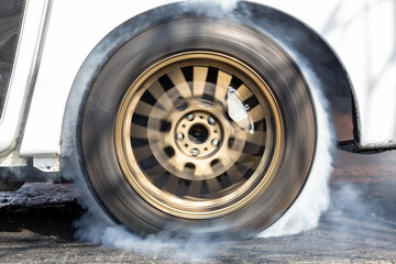 Car wheel spinning wheel and smoking, Race car doing lot of smoke on race track, Car wheel drifting...