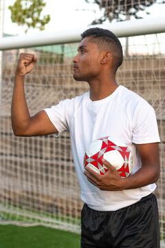 Latin soccer player with ball in hand celebrating a goal. Concept of a player celebrating a goal with the ball in hand