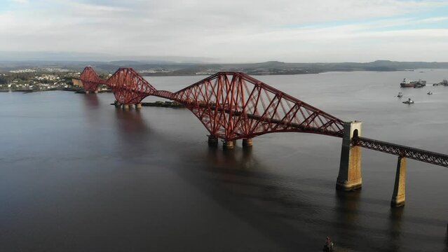 Drone shot of a train crossing the the Forth Bridge in Queensferry, Scotland.