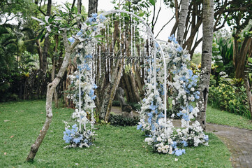 Fairy-tale with blue and white accent flowers theme. Clean white table setting for wedding ceremony or reception. Family intimacy dinner outdoors with starlight.