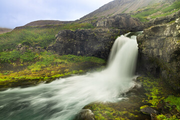 Obraz premium Gongumannafoss, one of the 5 waterfalls below Dynjandi waterfall located in Arnarfjordur, Iceland. It is the largest waterfall in the Westfjords and has a total height of 100 metres.