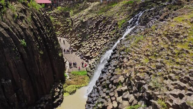 Aerial drone shot of prism rocks and a waterfall