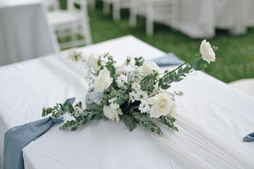 Fairy-tale with blue and white accent flowers theme. Clean white table setting for wedding ceremony or reception. Family intimacy dinner outdoors with starlight.