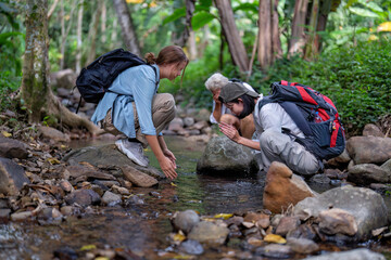 Backpack tourist travel hiking outdoor adventure use water stream from mountain washing hand