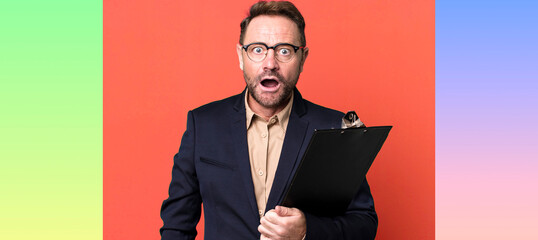 middle age man looking very shocked or surprised with an inventory. business concept