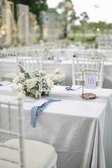 Fairy-tale with blue and white accent flowers theme. Clean white table setting for wedding ceremony...