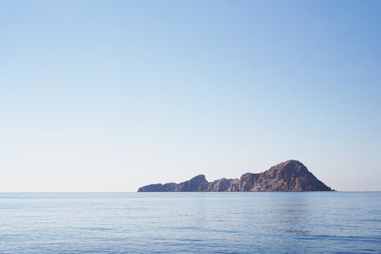 Small rocky Island in the sea. Holidays in Turkey. Sea cruise. Photo on a hot summer day