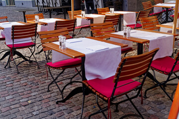 Terrace with laid tables of restaurant at the old town of Zürich on a sunny autumn day. Photo taken October 30th, 2022, Zurich, Switzerland.