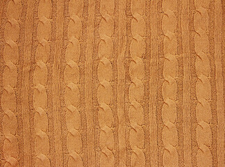 the texture of an orange woolen fabric tied with a pigtail pattern