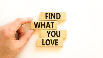 Find what you love symbol. Concept words Find what you love on wooden blocks. Beautiful white table white background. Businessman hand. Business, psychological find what you love concept. Copy space.