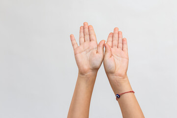 close up view of raised hand of a kid against white background