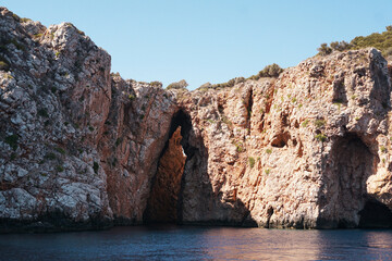 Fototapeta premium Suluada Island coastal view on the Mediterranean Sea. Sea caves in the mediterranean