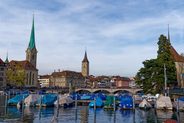 Skyline of the old town of City of Zürich with churches Women's Minster and St. Peter and Limmat River on a blue cloudy autumn day. Photo taken October 30th, 2022, Zurich, Switzerland.