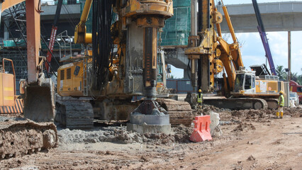 Fototapeta na wymiar MALACCA, MALAYSIA -MARCH 12, 2015: Bore pile rig machine at the construction site in Malacca, Malaysia. The machine used to driven pile for building foundation work.