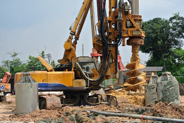Fototapeta na wymiar MALACCA, MALAYSIA -MARCH 12, 2015: Bore pile rig machine at the construction site in Malacca, Malaysia. The machine used to driven pile for building foundation work.