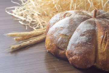Pumpkin bread made in the shape of a pumpkin on a wooden table