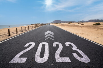 2023 New Year road trip travel and future vision concept . Nature landscape with highway road leading forward to happy new year celebration in the beginning of 2023 for fresh and successful start