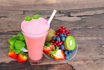 Strawberry yogurt fruit juice smoothie pink colorful fruit juice milkshake blend beverage healthy high protein the taste yummy In glass drink episode morning on wood background.