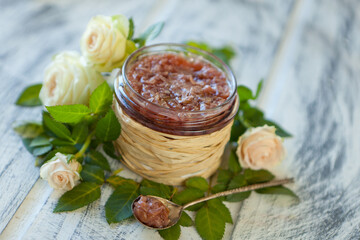 pink jam with rose petals-Rose petal jam in a glass jar on neutral grey kitchen table with copy...