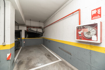 Garage space on the ground floor of a residential building with a fire-fighting system