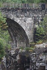 Naklejka premium Garve, Scotland, United Kingdom: The Victorian-era Little Garve Bridge over Black Water, a river in the Scottish Highlands.
