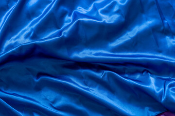 blue satin fabric background with water and wrinkles