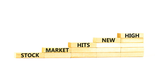 Stock market hits new high symbol. Concept words Stock market hits new high on wooden blocks on a beautiful white table white background. Business and stock market hits new high concept. Copy space.