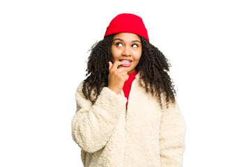 Young african american woman wearing winter clothes isolated relaxed thinking about something looking at a copy space.