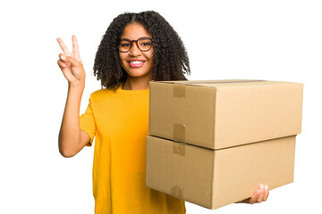 Young african american woman moving to other house while picking up a box full of things isolated showing number two with fingers.