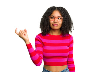 Young african american woman isolated pointing with finger at you as if inviting come closer.