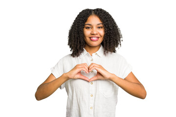 Young african american woman isolated smiling and showing a heart shape with hands.
