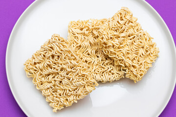 Uncooked Instant Noodles on White Plate. Raw Pasta. Dry Asian Fast Food. Quick Lunch