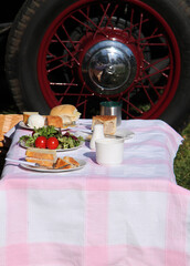 A Vintage Traditional Picnic Besides a Classic Car.
