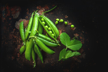 young green peas rustic. healthy fresh green peas and pods on rustic background, texture