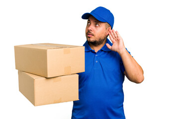 Fototapeta na wymiar Delivery caucasian man isolated trying to listening a gossip.