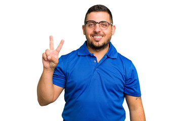 Fototapeta premium Young caucasian man isolated joyful and carefree showing a peace symbol with fingers.