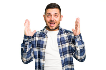 Young caucasian man isolated receiving a pleasant surprise, excited and raising hands.