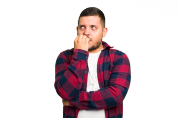 Young caucasian man isolated biting fingernails, nervous and very anxious.